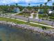 Beautiful homes line the street in this waterfront community with mature palm trees and manicured lawns at 43 Edgewater Dr, Dunedin, FL 34698