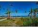 Waterfront view with palms and landscaping, just steps from the property at 43 Edgewater Dr, Dunedin, FL 34698