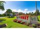 Beautiful hotel exterior with well-maintained grounds and a welcoming sign at 43 Edgewater Dr, Dunedin, FL 34698