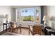 Bright living room featuring two chairs and a large window with beautiful water views at 43 Edgewater Dr, Dunedin, FL 34698