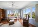 Well-lit living room with wicker furniture, large windows, and scenic waterfront views at 43 Edgewater Dr, Dunedin, FL 34698