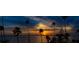 Scenic waterfront sunset with palm trees silhouetted against a colorful sky at 43 Edgewater Dr, Dunedin, FL 34698