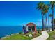 Charming welcome to Dunedin sign featuring tropical palms and waterfront views at 43 Edgewater Dr, Dunedin, FL 34698