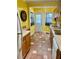 Cozy kitchen with warm yellow walls, tile floors, wood cabinets and modern appliances at 4634 Iris N St, St Petersburg, FL 33714