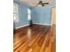 Inviting living room featuring gleaming hardwood floors, light blue walls, and ample natural light at 4634 Iris N St, St Petersburg, FL 33714