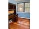 Home office with hardwood floors, blue walls and a vintage desk, creating a functional workspace at 4634 Iris N St, St Petersburg, FL 33714