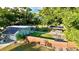 Aerial view of a well-maintained home with a fenced yard, lush greenery, and a covered parking area at 4901 Taylor N St, St Petersburg, FL 33714