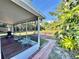 View of a well-manicured backyard with a patio area, lush greenery, and outdoor seating at 4901 Taylor N St, St Petersburg, FL 33714