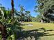 Spacious backyard with mature trees, lush greenery, and a cozy firepit area for outdoor enjoyment at 4901 Taylor N St, St Petersburg, FL 33714