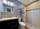 Bathroom featuring tiled shower, modern fixtures, vanity with ample storage, and patterned accent wall at 4901 Taylor N St, St Petersburg, FL 33714