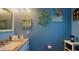 Charming bathroom with light blue walls, decorative turtle, and granite-topped vanity at 4901 Taylor N St, St Petersburg, FL 33714