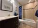 Bright bathroom featuring tiled shower-tub, large mirror, and modern vanity with drawers at 4901 Taylor N St, St Petersburg, FL 33714