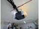 Close-up view of a modern Chamberlain garage door opener attached to the ceiling inside the garage at 4901 Taylor N St, St Petersburg, FL 33714