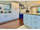 Open kitchen with white cabinets, granite countertops, a central island, and contrasting flooring at 4901 Taylor N St, St Petersburg, FL 33714