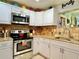 Close-up of a well-equipped kitchen with stainless steel oven and microwave, granite countertops, and ample storage at 4901 Taylor N St, St Petersburg, FL 33714