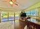 Bright living room with sliding glass doors to the patio, a large TV, and comfortable seating at 4901 Taylor N St, St Petersburg, FL 33714