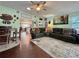 Cozy living room with hardwood floors, a comfortable leather sectional, and an open view to the kitchen at 4901 Taylor N St, St Petersburg, FL 33714