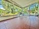 Enclosed sunroom featuring tile floors, outdoor chairs, and a view of the landscaped yard at 4901 Taylor N St, St Petersburg, FL 33714