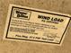 Wayne Dalton wind load sticker with certification information and the PSF test load value at 4901 Taylor N St, St Petersburg, FL 33714