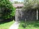 Enclosed front entrance with gate and walkway lined with green foliage at 5301 Hopedale Dr, Tampa, FL 33624