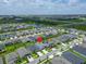 Stunning aerial view of home in a Primary-planned community with lush greenery and lake views at 5415 Limelight Dr, Apollo Beach, FL 33572