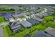Overhead view of neighborhood featuring green lawns and mature trees, situated close to a tranquil lake at 5415 Limelight Dr, Apollo Beach, FL 33572