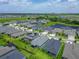 An aerial view showcasing the home's position within the community, highlighting nearby green spaces and landscaping at 5415 Limelight Dr, Apollo Beach, FL 33572