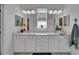 Bright bathroom with double vanity, marble countertops, and stylish fixtures at 5415 Limelight Dr, Apollo Beach, FL 33572