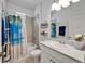 Well-lit bathroom featuring a tub, shower with decorative curtain and granite countertops at 5415 Limelight Dr, Apollo Beach, FL 33572