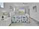 A bright and airy bedroom with white furniture and a coastal-themed comforter at 5415 Limelight Dr, Apollo Beach, FL 33572