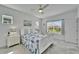 Bedroom with white furnishings, ceiling fan, a view of the backyard, and plenty of natural light at 5415 Limelight Dr, Apollo Beach, FL 33572