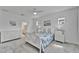 Bright primary bedroom with white furniture, coastal-themed bedding, and ample natural light at 5415 Limelight Dr, Apollo Beach, FL 33572