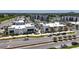 Aerial view of several modern commercial buildings with street parking, palm trees, and contemporary designs at 5415 Limelight Dr, Apollo Beach, FL 33572