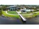 Modern community center featuring a lake pier, a pool, an outdoor workout area, and manicured green space at 5415 Limelight Dr, Apollo Beach, FL 33572