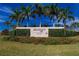 Stone 'Waterset by Newland' sign surrounded by vibrant greenery and palm trees under a bright blue sky at 5415 Limelight Dr, Apollo Beach, FL 33572