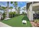 Community area featuring a cornhole setup, surrounded by lush landscaping and well-maintained grounds for outdoor fun at 5415 Limelight Dr, Apollo Beach, FL 33572