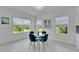 Dining area featuring a glass table and comfortable blue chairs with views of the outdoors at 5415 Limelight Dr, Apollo Beach, FL 33572