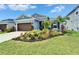 Attractive single-story home boasts a lush lawn and colorful tropical landscaping at 5415 Limelight Dr, Apollo Beach, FL 33572