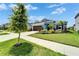 Charming single-story home with a well-manicured lawn and beautiful landscaping at 5415 Limelight Dr, Apollo Beach, FL 33572