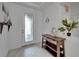 Bright foyer with decorative door, coastal decor, and light wood-look tile flooring at 5415 Limelight Dr, Apollo Beach, FL 33572