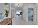 Bright hallway with white tile floors, high ceilings, and views to the living area at 5415 Limelight Dr, Apollo Beach, FL 33572