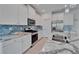 Modern kitchen featuring an island, stainless appliances, stone countertops, and ample cabinetry at 5415 Limelight Dr, Apollo Beach, FL 33572