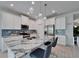 Bright kitchen with stainless steel appliances, marble countertop island, and stylish backsplash at 5415 Limelight Dr, Apollo Beach, FL 33572