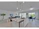 Open-concept kitchen featuring an island, stainless appliances, and an adjacent living space at 5415 Limelight Dr, Apollo Beach, FL 33572
