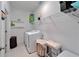 Efficient laundry room with washer, dryer, storage shelves and decorative accents at 5415 Limelight Dr, Apollo Beach, FL 33572