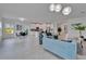 Bright, open living area featuring modern furnishings and a seamless connection to the dining and kitchen at 5415 Limelight Dr, Apollo Beach, FL 33572