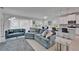 Open-concept living room featuring modern decor, a sectional sofa, and bright natural light at 5415 Limelight Dr, Apollo Beach, FL 33572