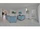 Bright living room featuring comfortable seating, a modern TV, and seamless flooring at 5415 Limelight Dr, Apollo Beach, FL 33572