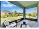 Relaxing screened-in patio featuring a comfortable chair and a view of the fenced backyard at 5415 Limelight Dr, Apollo Beach, FL 33572