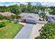Aerial view of home showcasing a long driveway and lush landscaping at 5473 Bayshore Dr, Seminole, FL 33772